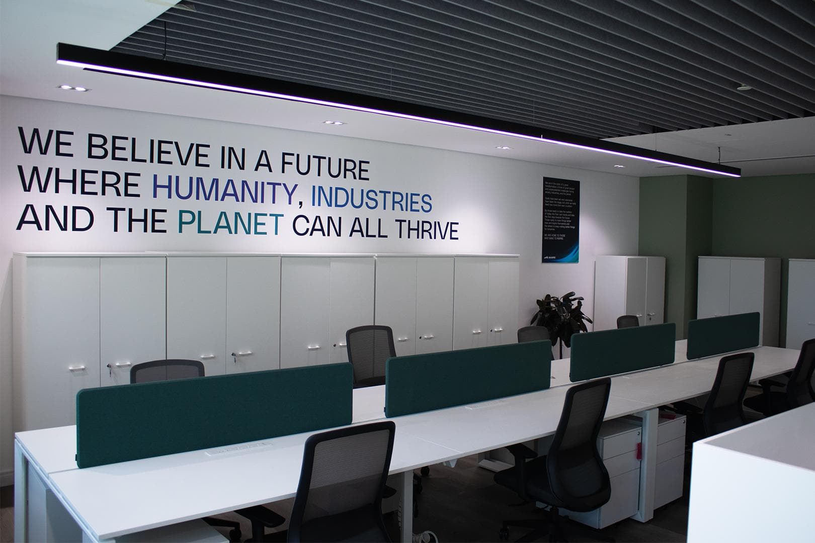 Maire Tecnimont office with acoustic baffle ceiling and brand mural